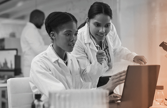 Researchers looking at screen with clinical trial regulations